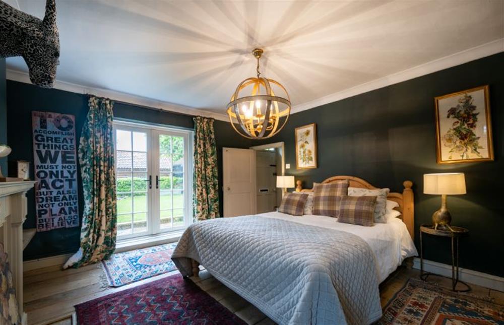Master bedroom with french doors to front of property at The Old Manor House, Brancaster near Kings Lynn