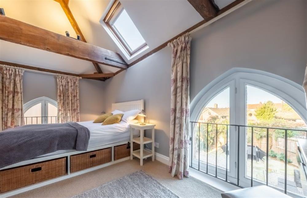 Master bedroom with courtyard garden view at The Old Methodist Chapel, Heacham near Kings Lynn