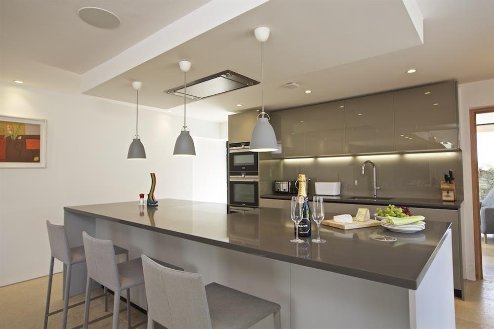 Kitchen with a stunning granite-topped central island at The Old Milking Shed in , Bantham