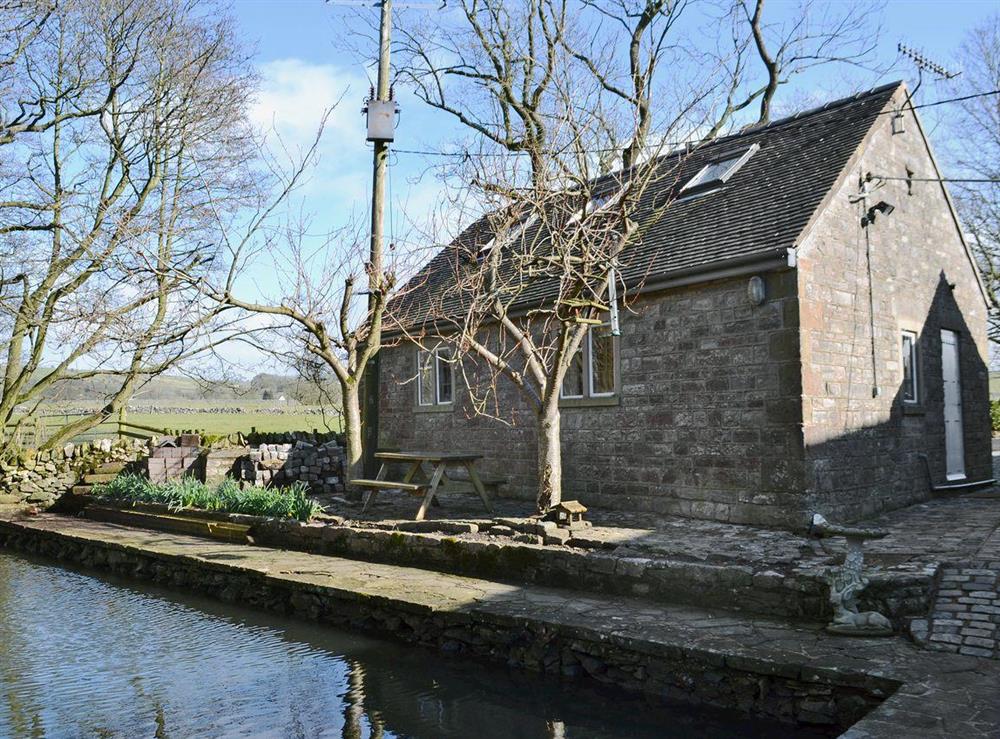 A stone built annexe by the riverside at The Old Mill Annexe in Buxton, Derbyshire