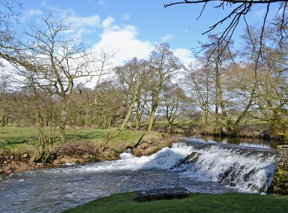 Riverside setting and surrounding Peak District countryside at The Old Mill Annexe in Buxton, Derbyshire