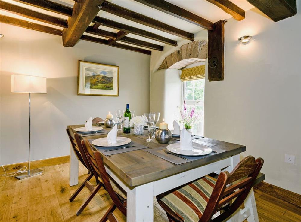 Elegant dining area with views overlooking the river at The Old Mill in Penrith, Cumbria
