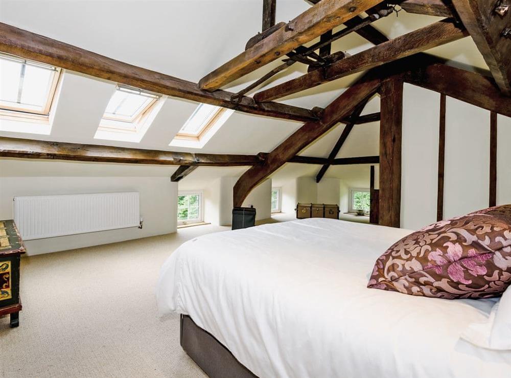 Impressive double bedroom with beams and en-suite with slipper bath at The Old Mill in Penrith, Cumbria