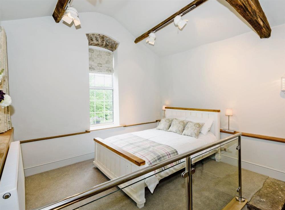 Luxurious split level room with beams, king size bed and wood burner (photo 2) at The Old Mill in Penrith, Cumbria
