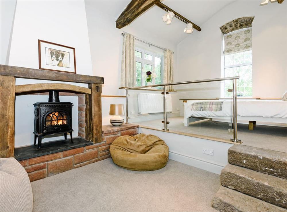 Luxurious split level room with beams, king size bed and wood burner at The Old Mill in Penrith, Cumbria