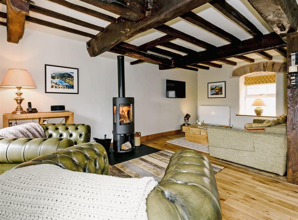 Warm and spacious living area with woodburner and river views at The Old Mill in Penrith, Cumbria
