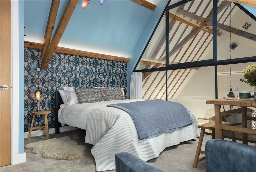 First floor: Mezzanine level bedroom two with 5ft king-size bed and en-suite shower room at The Old Mission Church, Paxford, near Chipping Campden