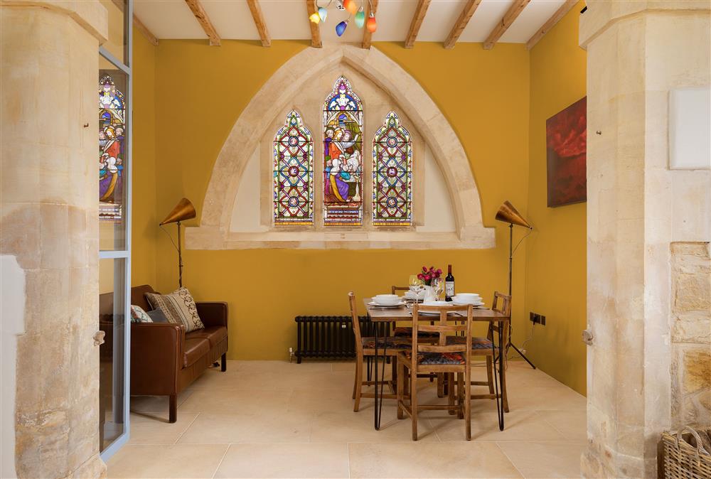 Ground floor: Dining area featuring original stained glass windows at The Old Mission Church, Paxford, near Chipping Campden