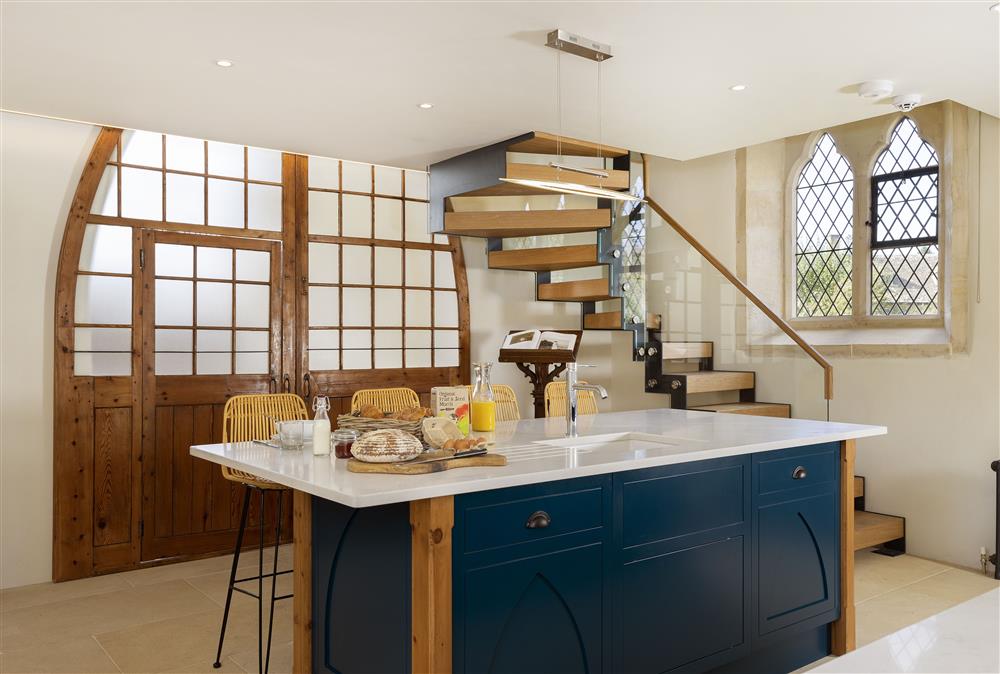 Ground floor: From the kitchen, original doors lead to bedroom one and the bespoke staircase leads up to the mezzanine 