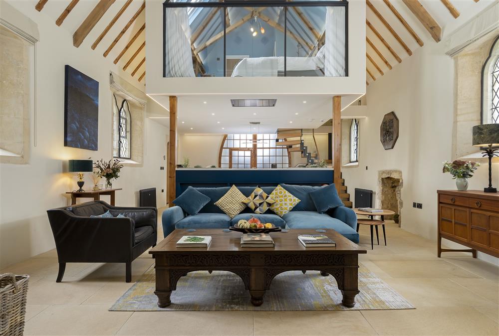 Ground floor: Open-plan living area featuring exposed beams and rafters and the stunning  floating mezzanine bedroom (photo 2)