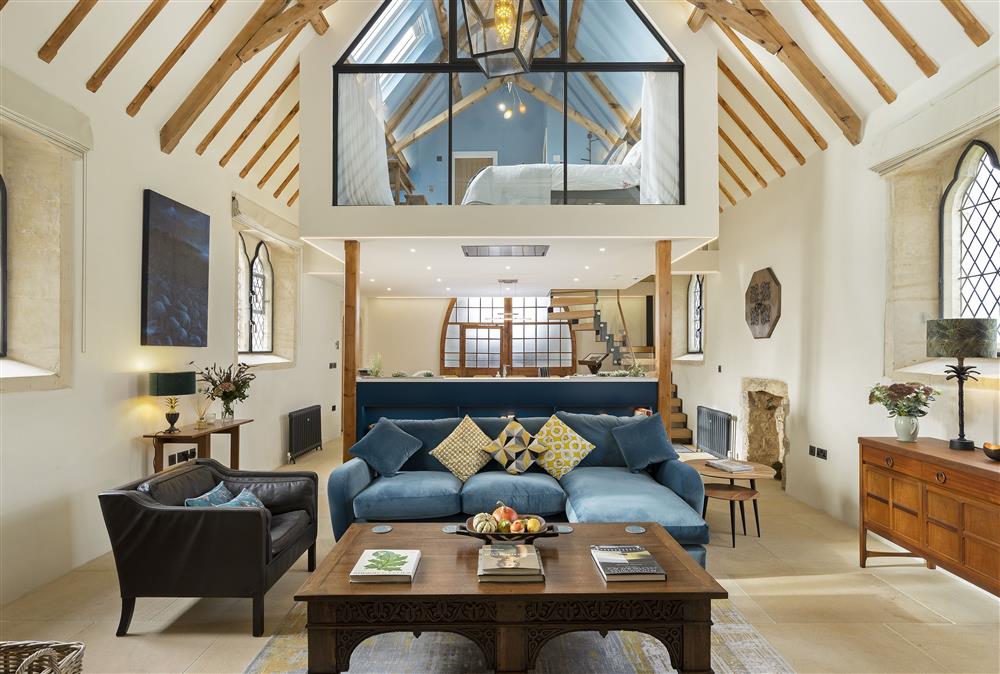 Ground floor: Open-plan living area featuring exposed beams and rafters and the stunning  floating mezzanine bedroom