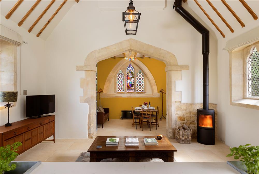 Ground floor:  Stunning living area leading through to the dining area featuring original restored lantern, exposed rafters and a cosy wood burning stove