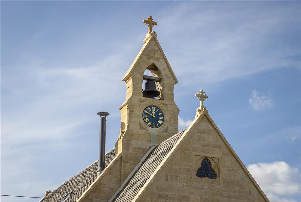 The fully restored clock face and bell tower at The Old Mission Church in Paxford at The Old Mission Church, Paxford, near Chipping Campden