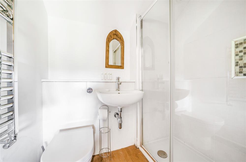 Bedroom four’s, en-suite shower room, wash basin and WC at The Old Piggeries, Burton Bradstock, Bridport
