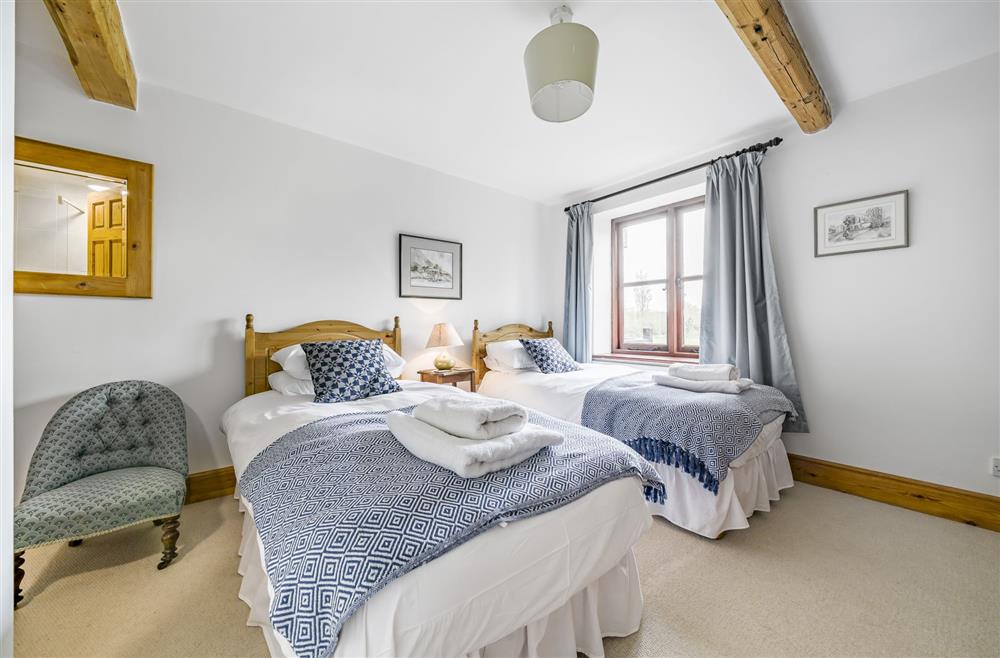 Bedroom two, situated on the ground floor, with 3’ twin single beds and en-suite shower room at The Old Piggeries, Burton Bradstock, Bridport