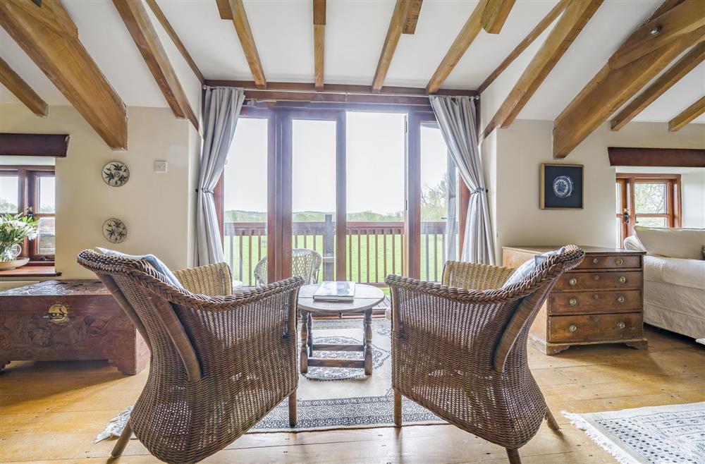Comfortable seating overlooking the beautiful views from the upper balcony at The Old Piggeries, Burton Bradstock, Bridport