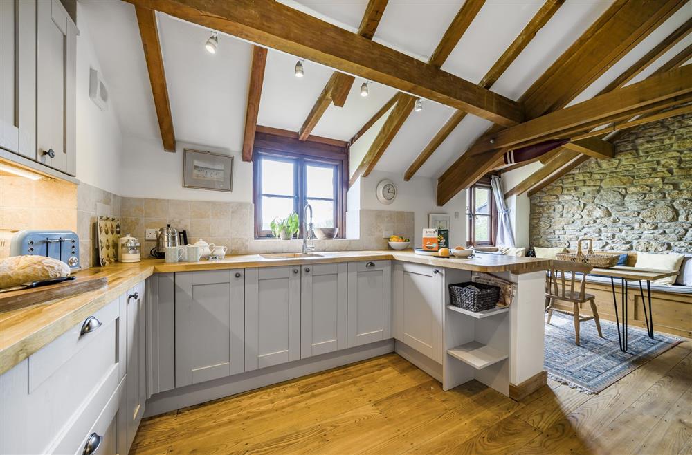 Well-equipped kitchen with informal breakfast area at The Old Piggeries, Burton Bradstock, Bridport