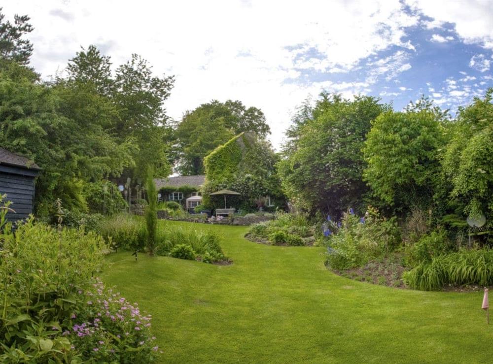 Well-maintained garden and grounds at The Old Pool House in Sevenhampton, near Cheltenham, Glos., Gloucestershire