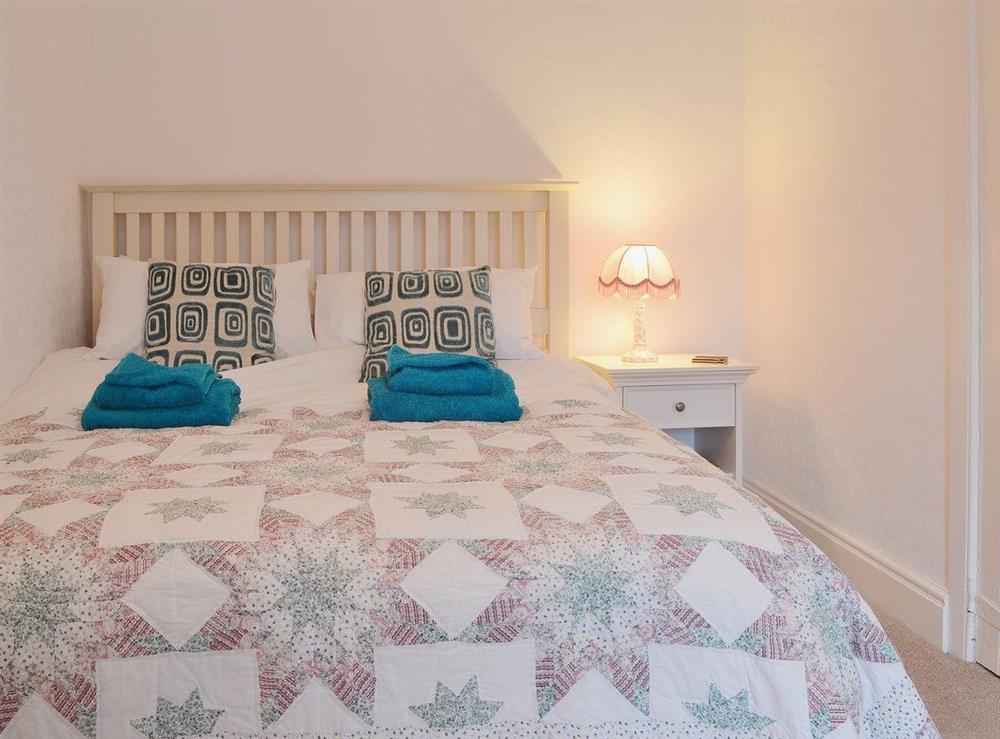 Beautiful bedding complements the modest double bedroom at The Old Post Office in Myddfai, near Llandovery, Dyfed