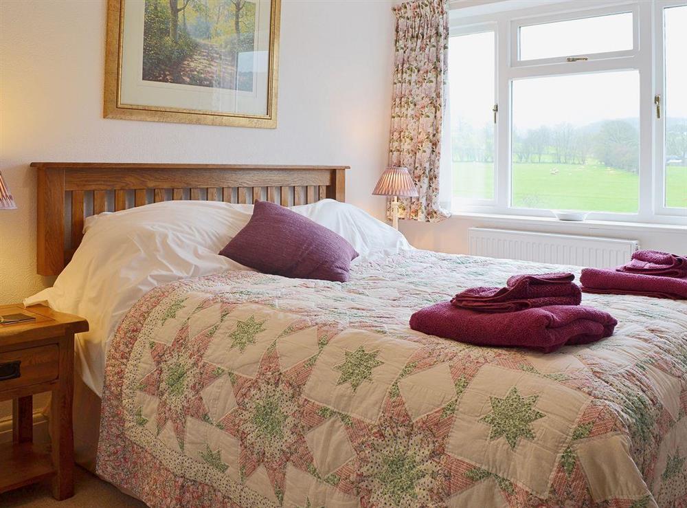 Relax in the lovely double bedroom with views out over the garden at The Old Post Office in Myddfai, near Llandovery, Dyfed