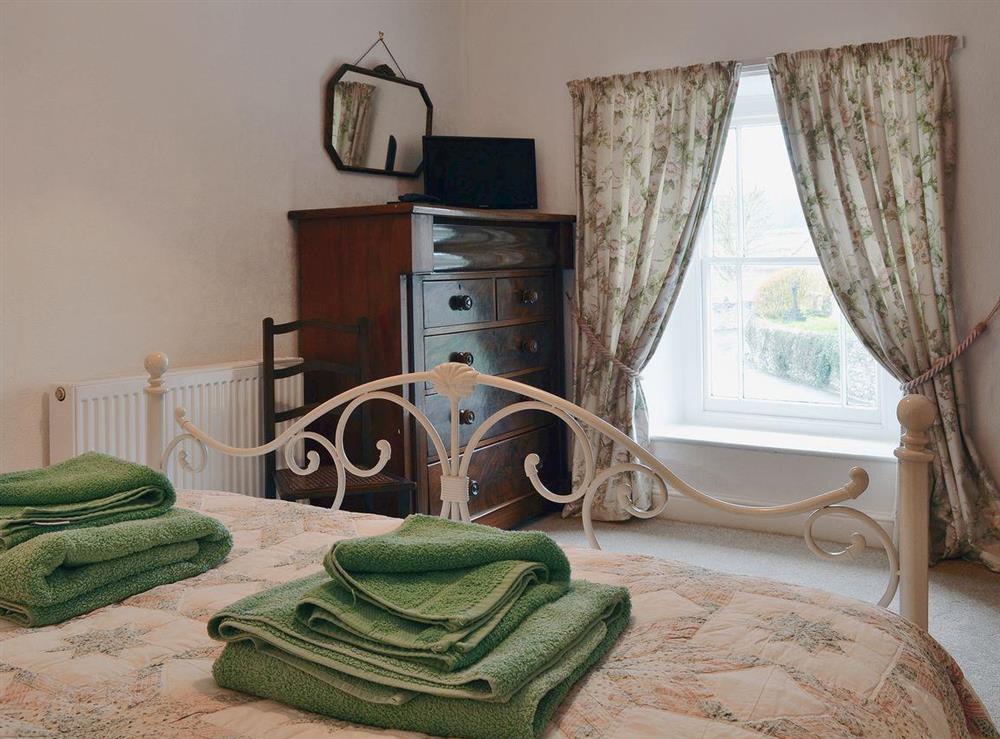 The double bedroom is well furnished and has a romantic feel at The Old Post Office in Myddfai, near Llandovery, Dyfed