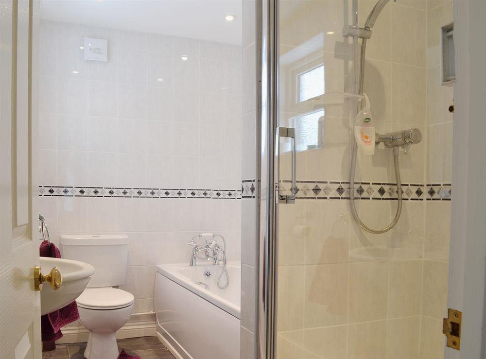The main bathroom has a shower cubicle as well as a shower over the bath at The Old Post Office in Myddfai, near Llandovery, Dyfed