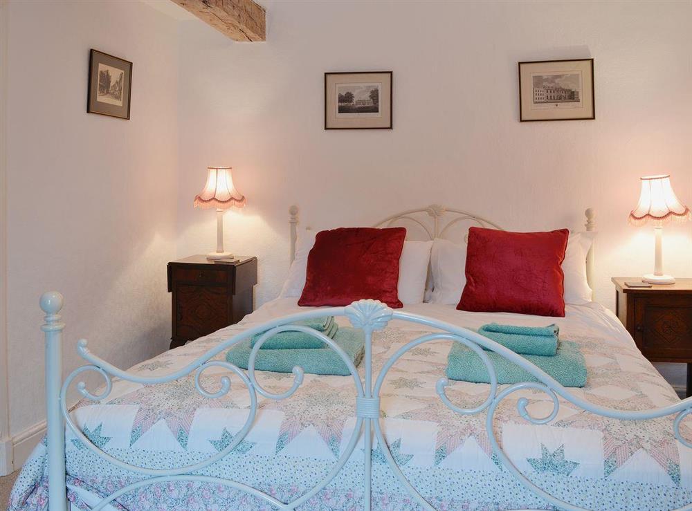 The second double bedroom has a kingsize bed and original exposed beams at The Old Post Office in Myddfai, near Llandovery, Dyfed