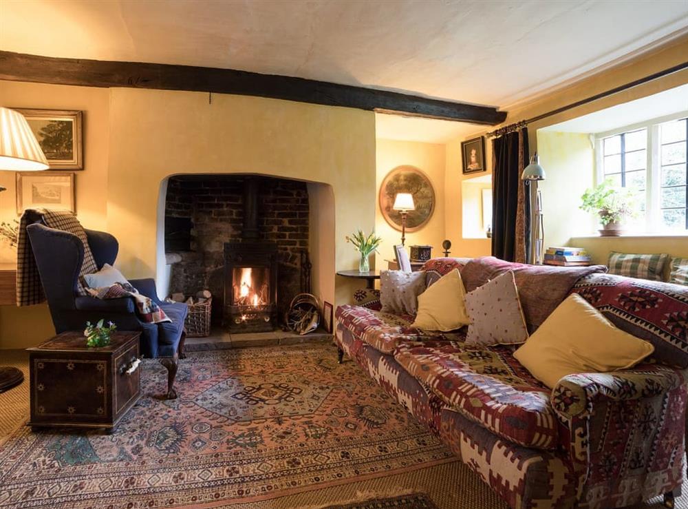 Cosy living room with wood burner (photo 2) at The Old Priory Cottage in Dunster, near Minehead, Somerset