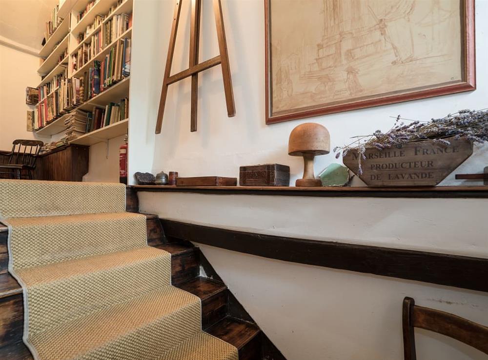 Stairs and library area at The Old Priory Cottage in Dunster, near Minehead, Somerset
