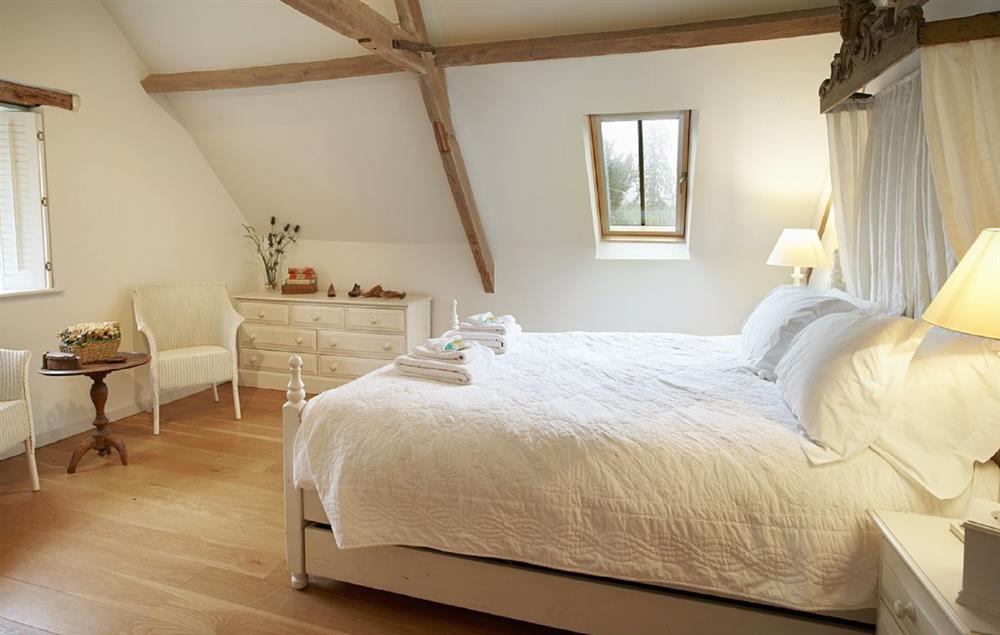 First floor large double bedroom with 5’ canopied bed at The Old Rectory and Coach House, North Tuddenham