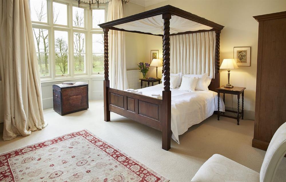 Master bedroom with four poster 5’ bed at The Old Rectory and Coach House, North Tuddenham