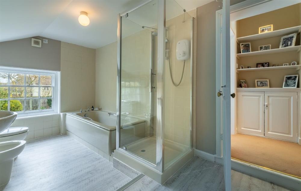 First floor: En-suite bathroom with bath and walk in shower at The Old Rectory, Heveningham
