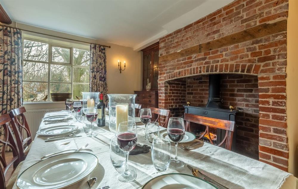 Ground floor: Dining room with seating for eight guests and wood burning stove (photo 2) at The Old Rectory, Heveningham