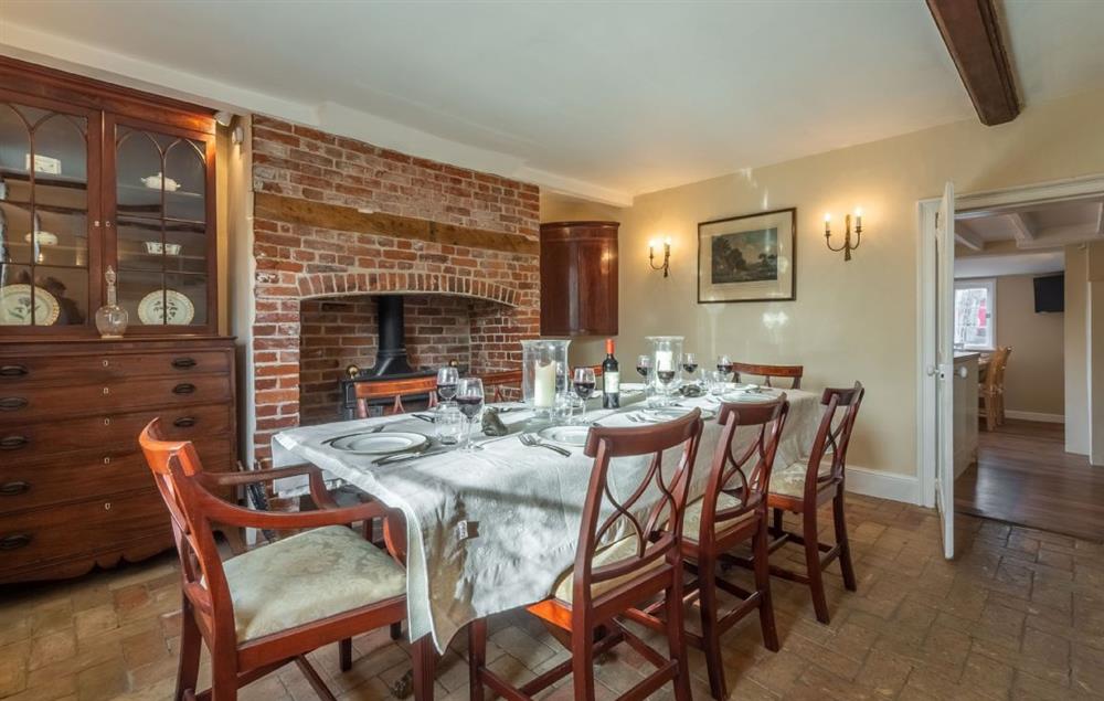 Ground floor: Dining room with seating for eight guests and wood burning stove at The Old Rectory, Heveningham
