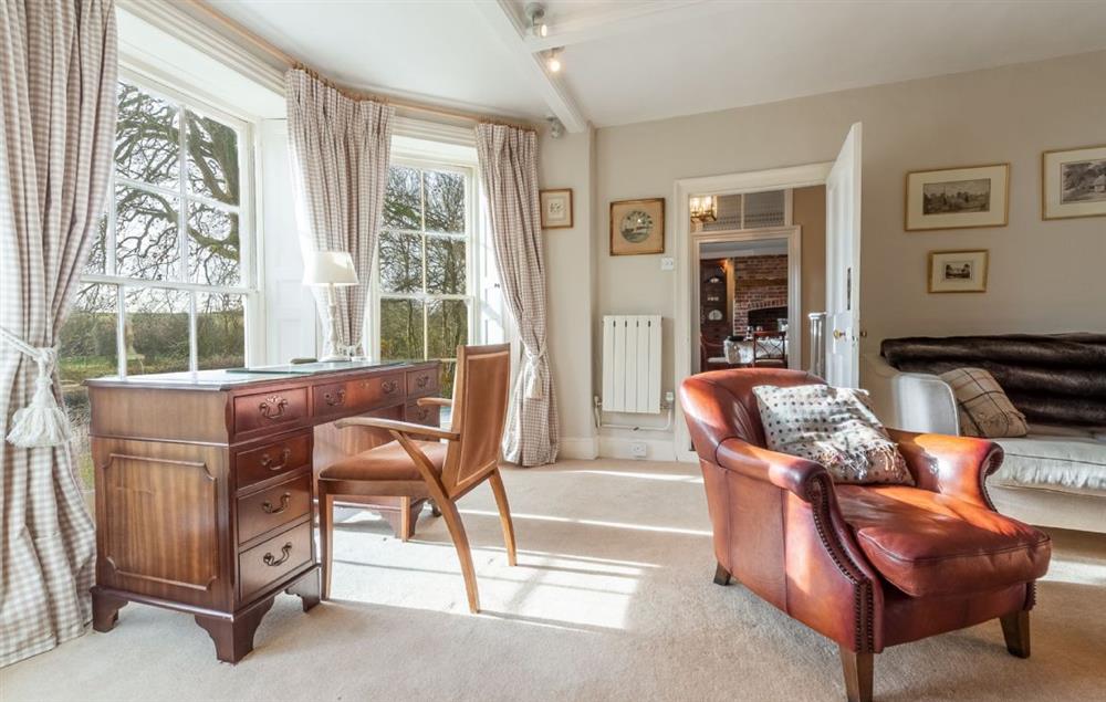 Ground floor: Family room with wood burning stove and bay window (photo 2) at The Old Rectory, Heveningham