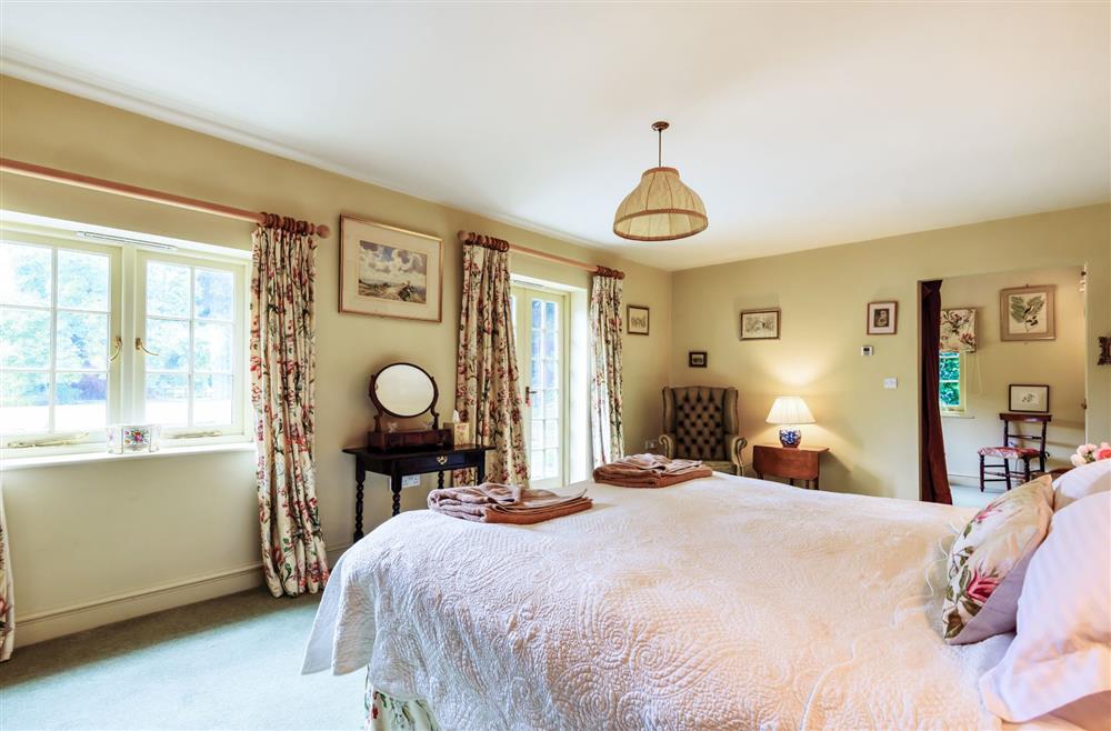 Bedroom one with a separate sitting and dressing area at The Old Rectory Lodge, Dorchester