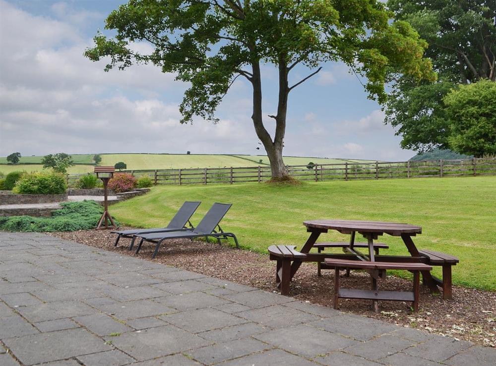 Picnic style seating area with loungers at The Old Sawmill in Bucknell, Shropshire