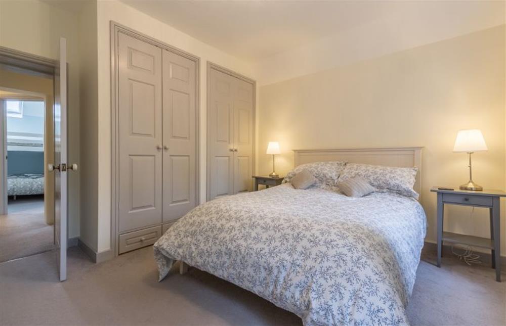 First floor: Bedroom three, king-size bed and built-in wardrobes at The Old School House, Docking near Kings Lynn