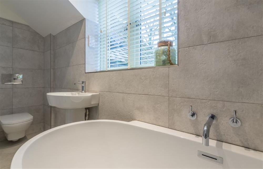 First floor: Family bathroom with  bath and separate shower at The Old School House, Docking near Kings Lynn