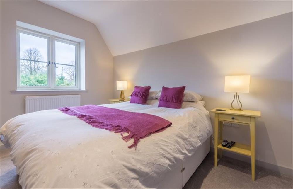 First floor: Master bedroom has king-size bed at The Old School House, Docking near Kings Lynn