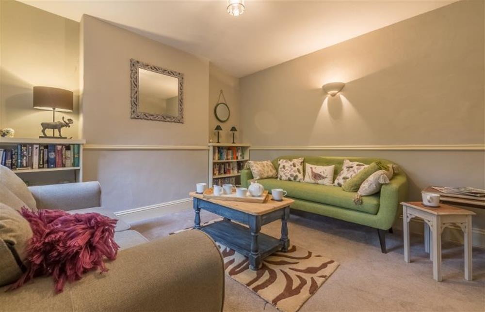 Ground floor: The Snug with sofas, coffee table and books