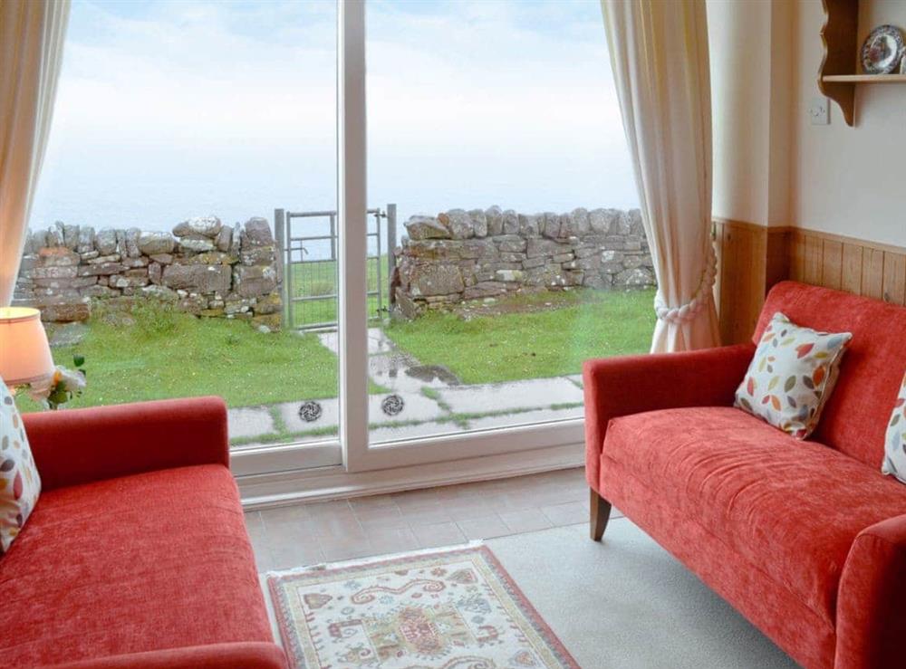 Hall/sitting room with sea view from picture window