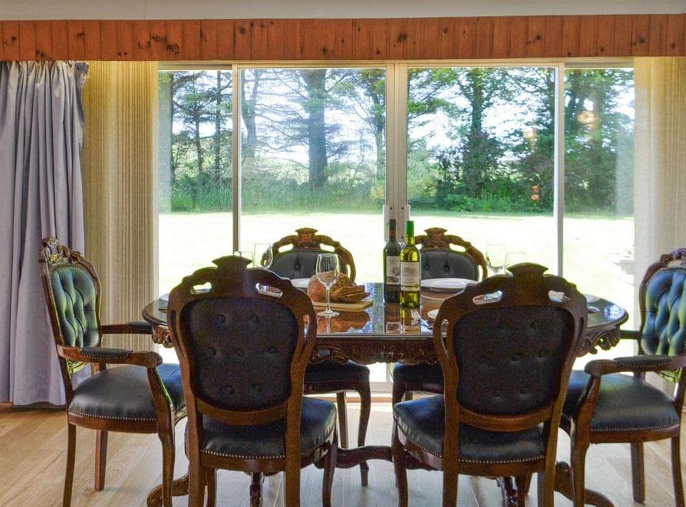 Dining area with patio door to garden at The Old School House in Portpatrick, near Stranraer, Wigtownshire