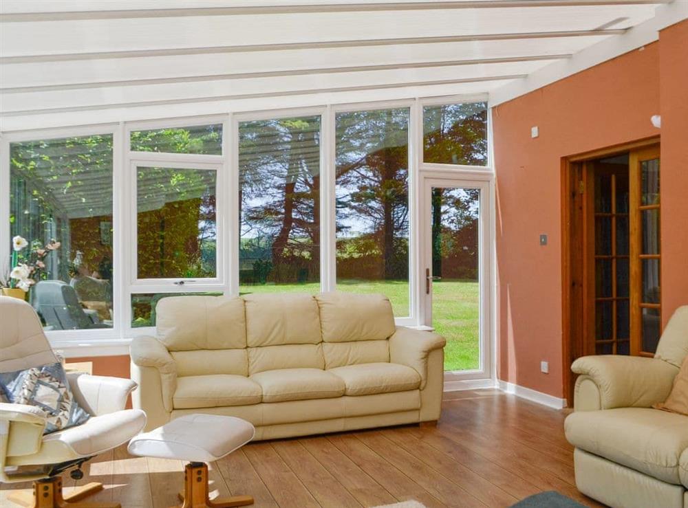 Spacious living area within the conservatory at The Old School House in Portpatrick, near Stranraer, Wigtownshire