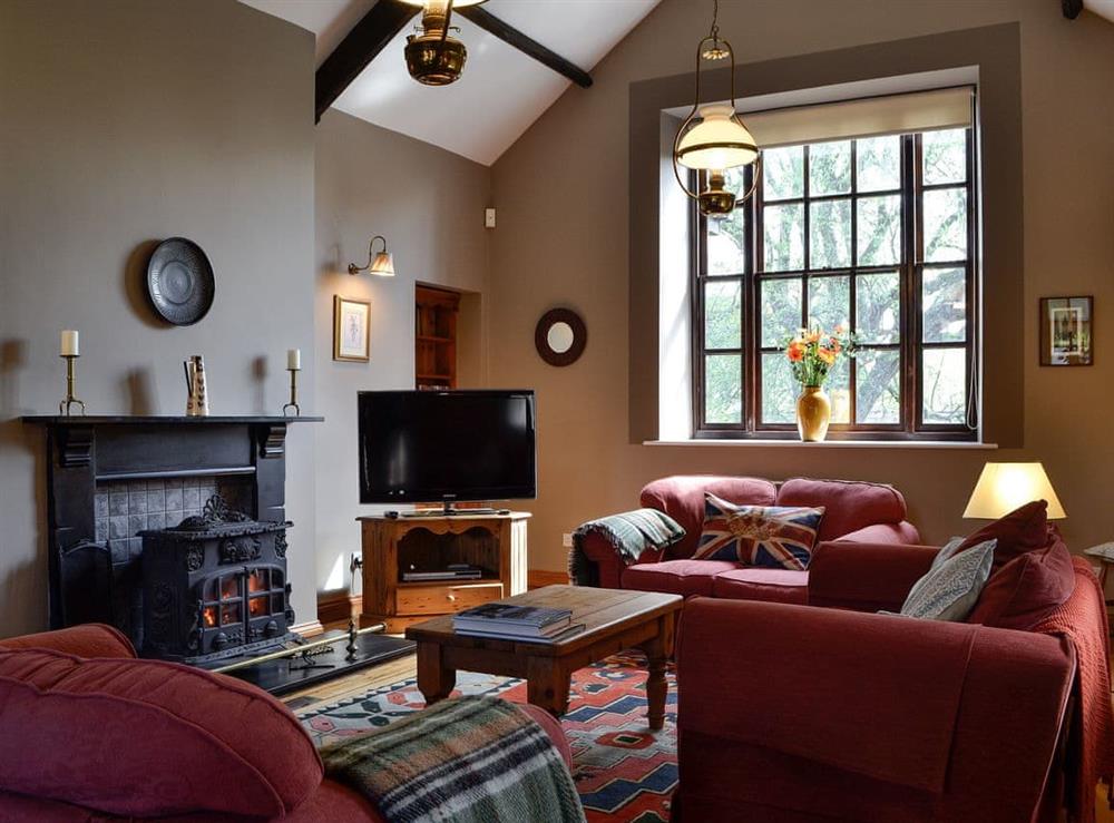 Living room with wood burner at The Old School Penallt in Penallt, near Monmouth, Gwent