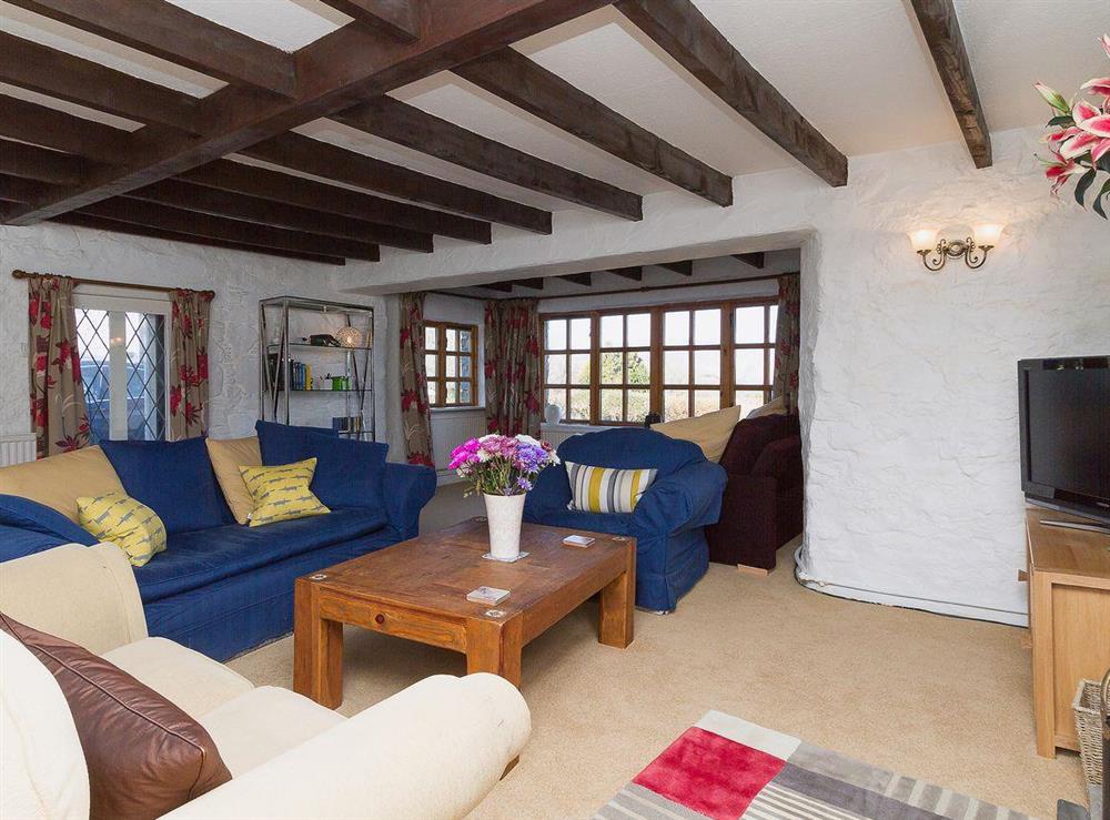 Comfortable sofas and armchairs make the living room a cosy place to relax at The Old Smithy in Appin, Argyll