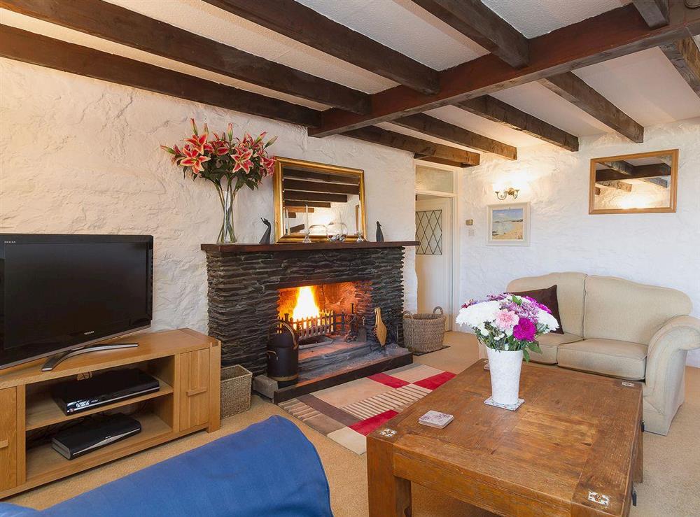 Spacious living room with open fireplace at The Old Smithy in Appin, Argyll