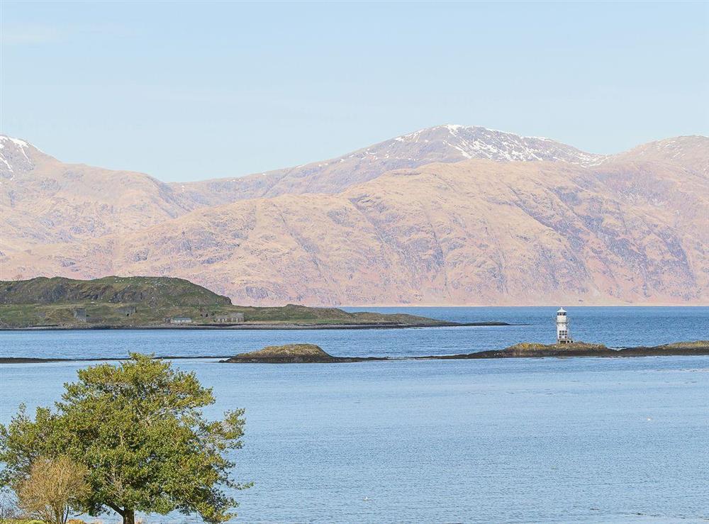 The Morven Hills frame the Port Appin lighthouse beautifully when viewed from the garden at The Old Smithy in Appin, Argyll