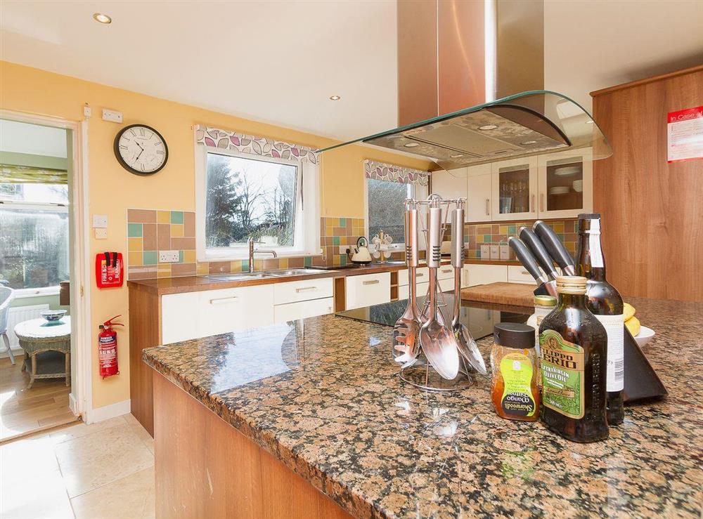 The well equipped modern kitchen has tiled floors and marble worktops at The Old Smithy in Appin, Argyll