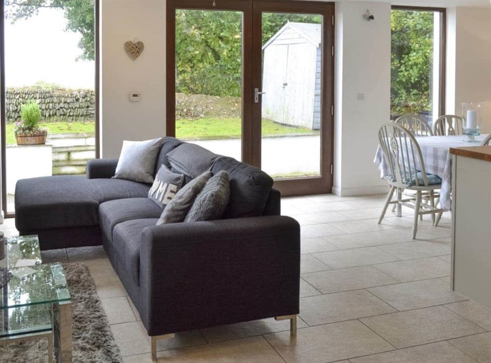 Open-plan living space with dining area, lounge and kitchen at The Old Smithy in Penelewey, near Truro, Cornwall